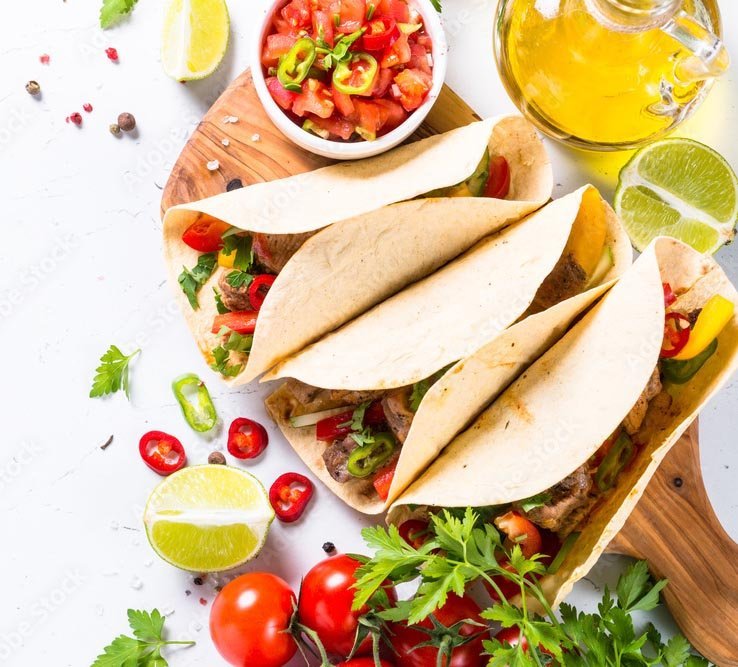 Catering staff serving tacos on site at an event